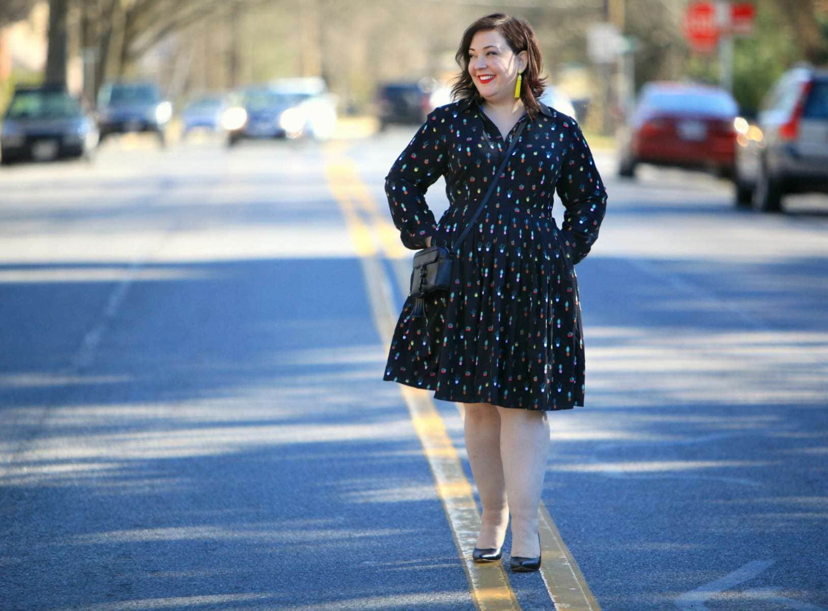 Wardrobe Oxygen in an Eloquii Conversational Dress, Rebecca Minkoff bag, and Baublebar tassel earrings