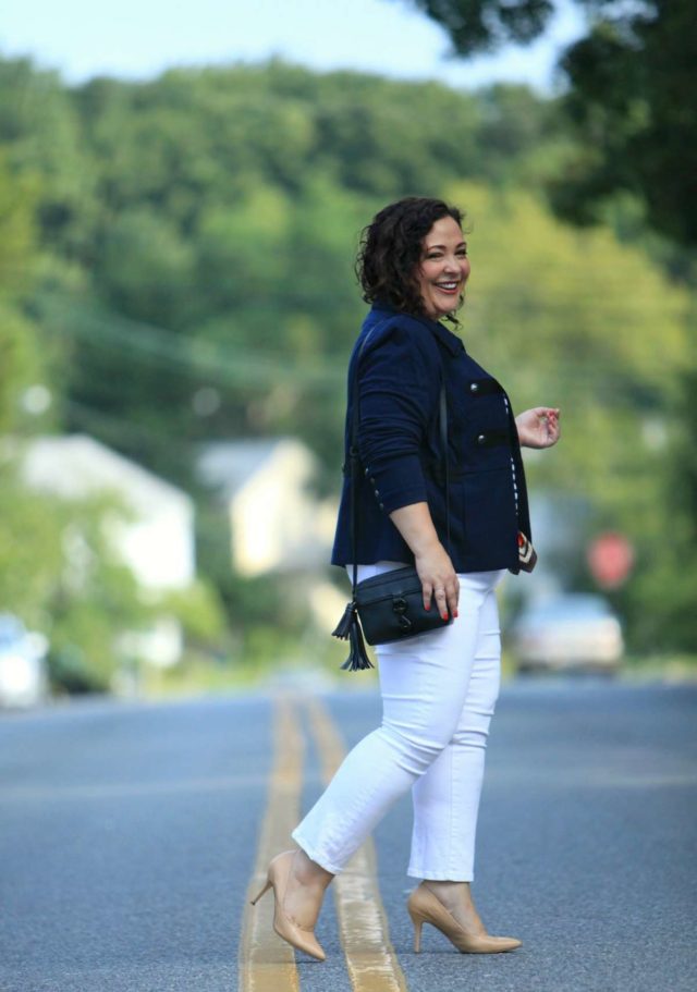 Wardrobe Oxygen in the cabi In the Band Jacket, Kick It Crop white jeans, and nude pumps. She's carrying the Rebecca Minkoff MAB Camera Bag