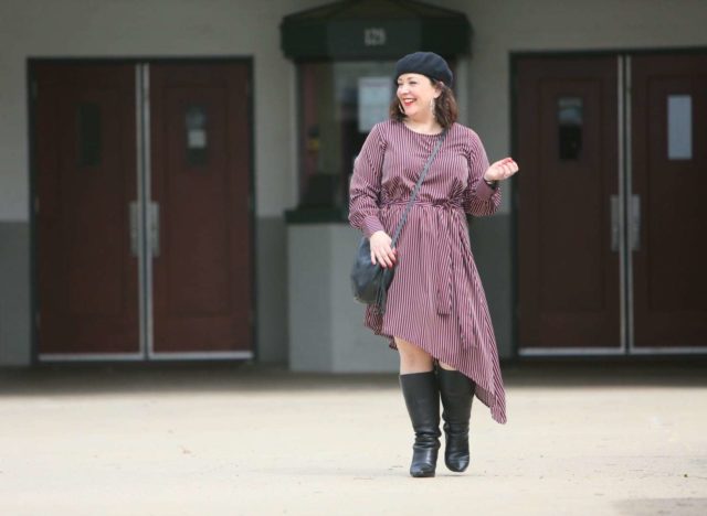 Stripes and a Beret at the Greenbelt Cinema 1 Woman in a red stripe long sleeve asymmetrical dress with a black beret, black round crossbody bag, and black knee-high boots. She is standing in front of the Greenbelt Cinema in Greenbelt, MD.