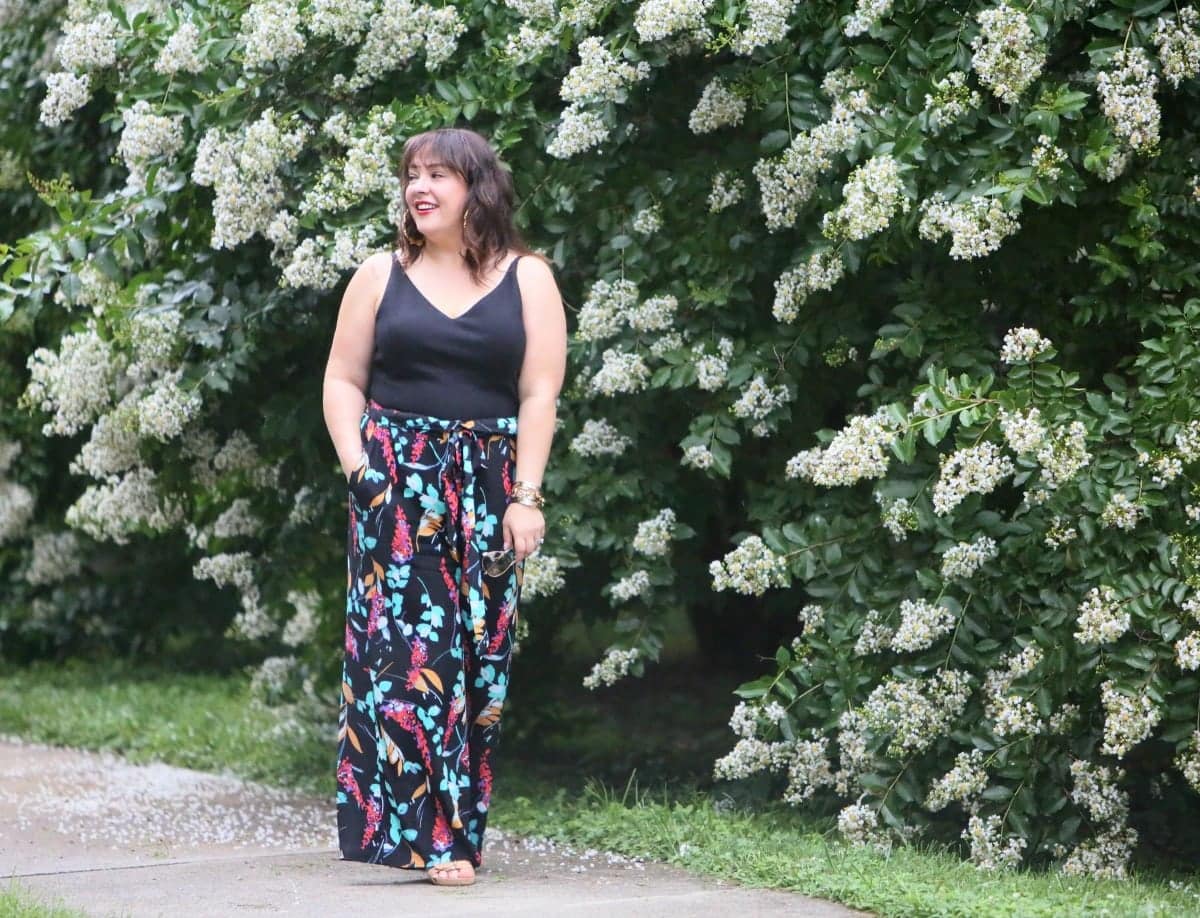 Over 40 fashion blogger Wardrobe Oxygen in a cabi ponte bralette, BP floral paperbag waist wide leg pants, and Aerosoles wedge sandals