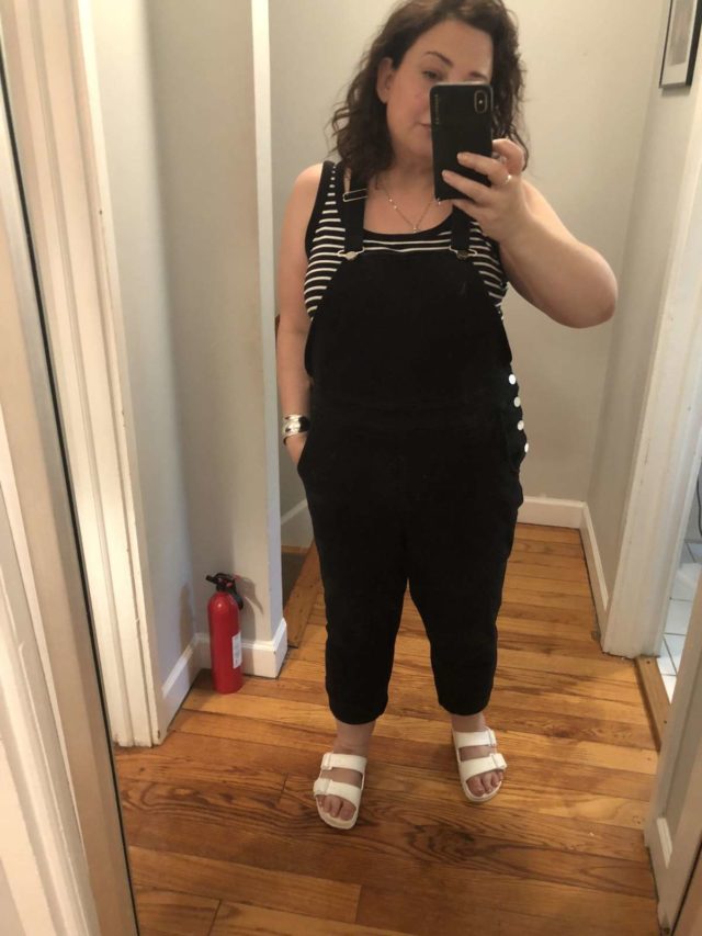 Wardrobe Oxygen in Universal Standard overalls with a striped tank and white EVA Birkenstock Arizona sandals