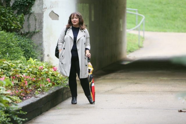 Alison Gary of Wardrobe Oxygen in a Universal Standard Trench Coat with Maryland Flag golf umbrella, navy Talbots cashmere sweater and black Chico's ponte pants