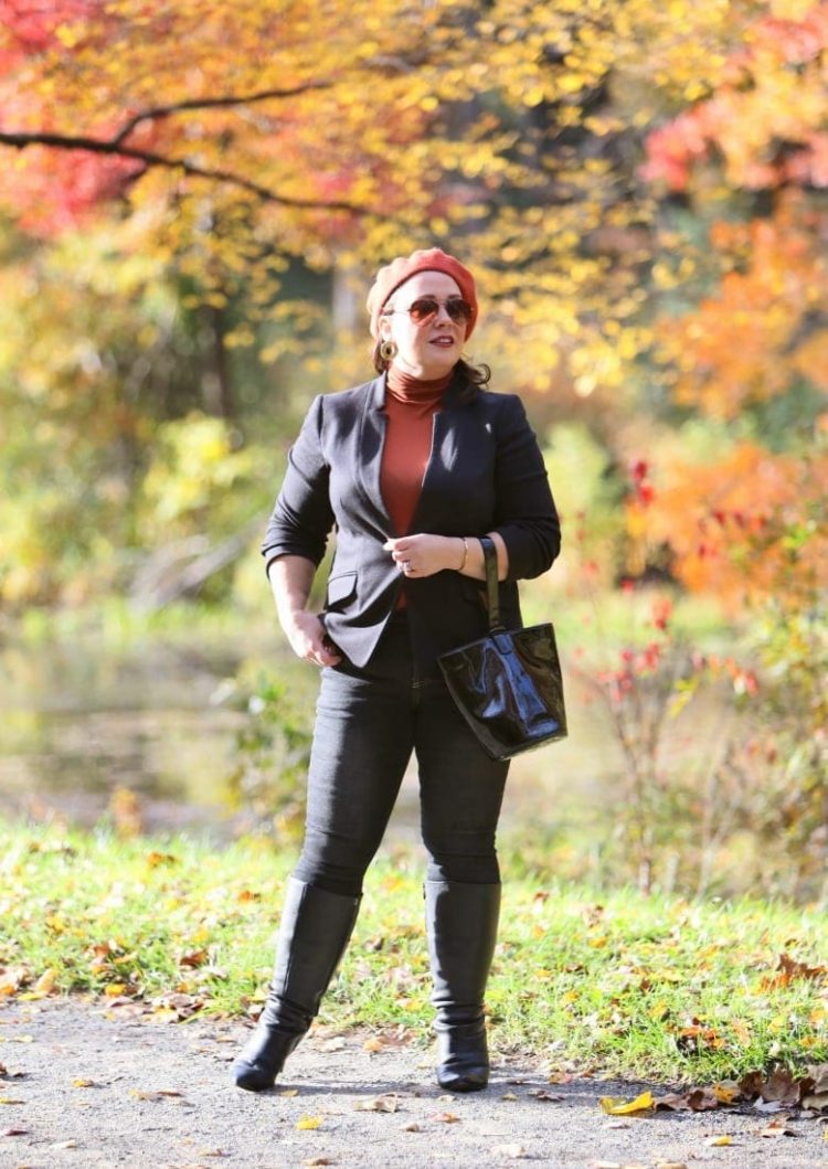 Universal Standard Seine skinny jeans styled with a black blazer, tall boots, and a pumpkin colored beret and turtleneck