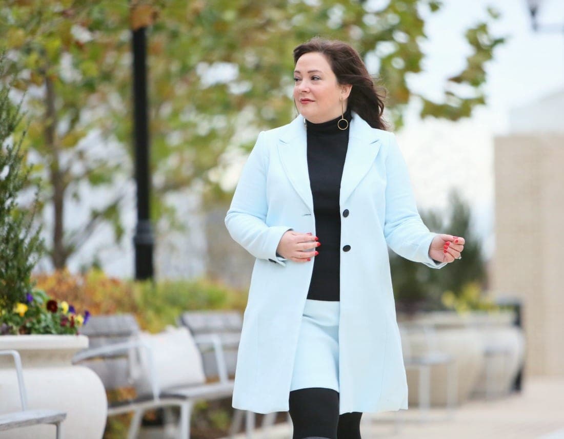 An ice blue skirt suit from White House Black Market styled with black boots and turtleneck as seen on Alison Gary of Wardrobe Oxygen