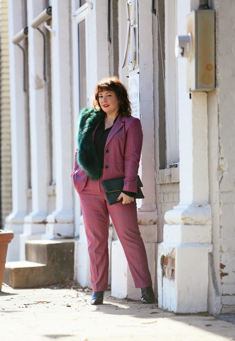 Wardrobe Oxygen in a pink plaid pantsuit from 1901 with a green faux fur stole and green Clare V. folder clutch