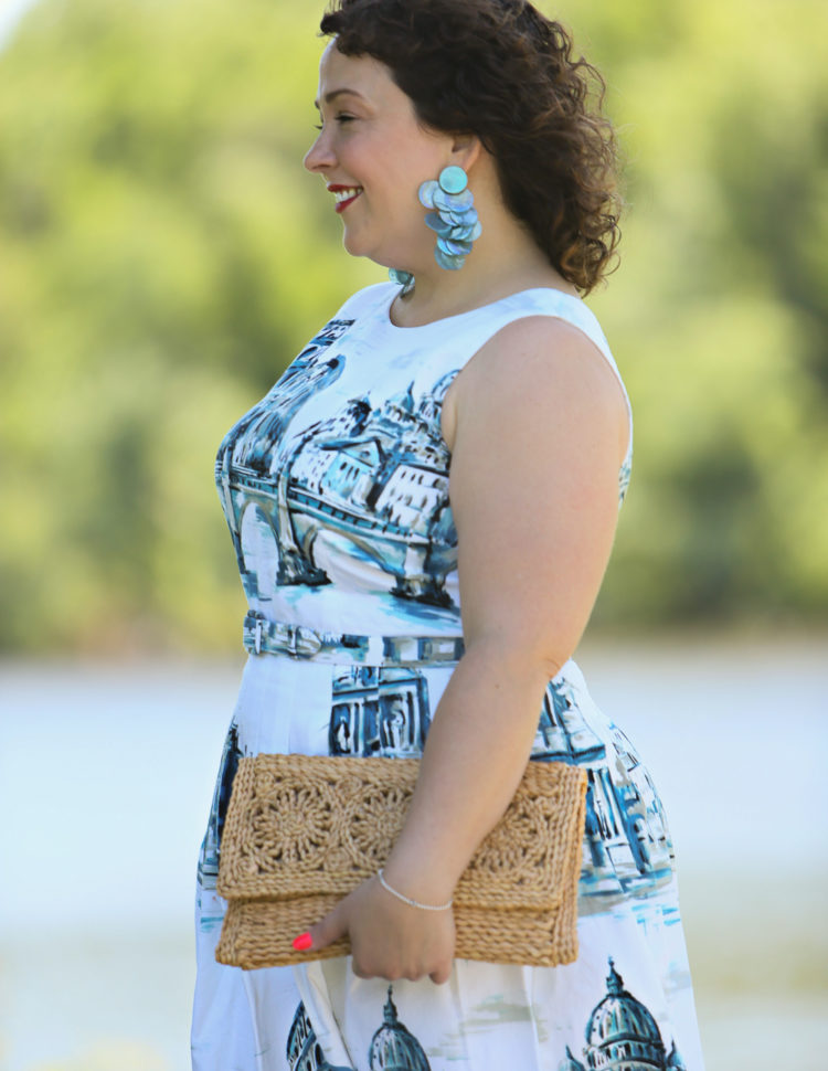 Rome-inspired printed fit and flare dress from Talbots styled with a woven straw clutch purse, Zara earrings, and Talbots wide width wedge sandals