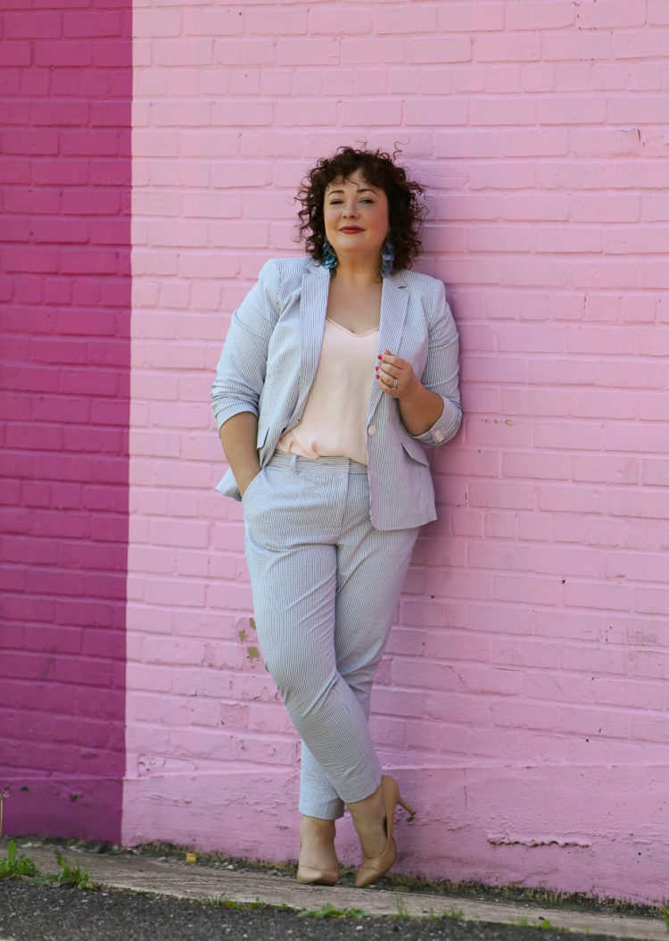 Wardrobe Oxygen in a seersucker pantsuit with blush J. Crew camisole, nude pumps from Nine West, and the Dagne Dover Essentials Clutch Wallet