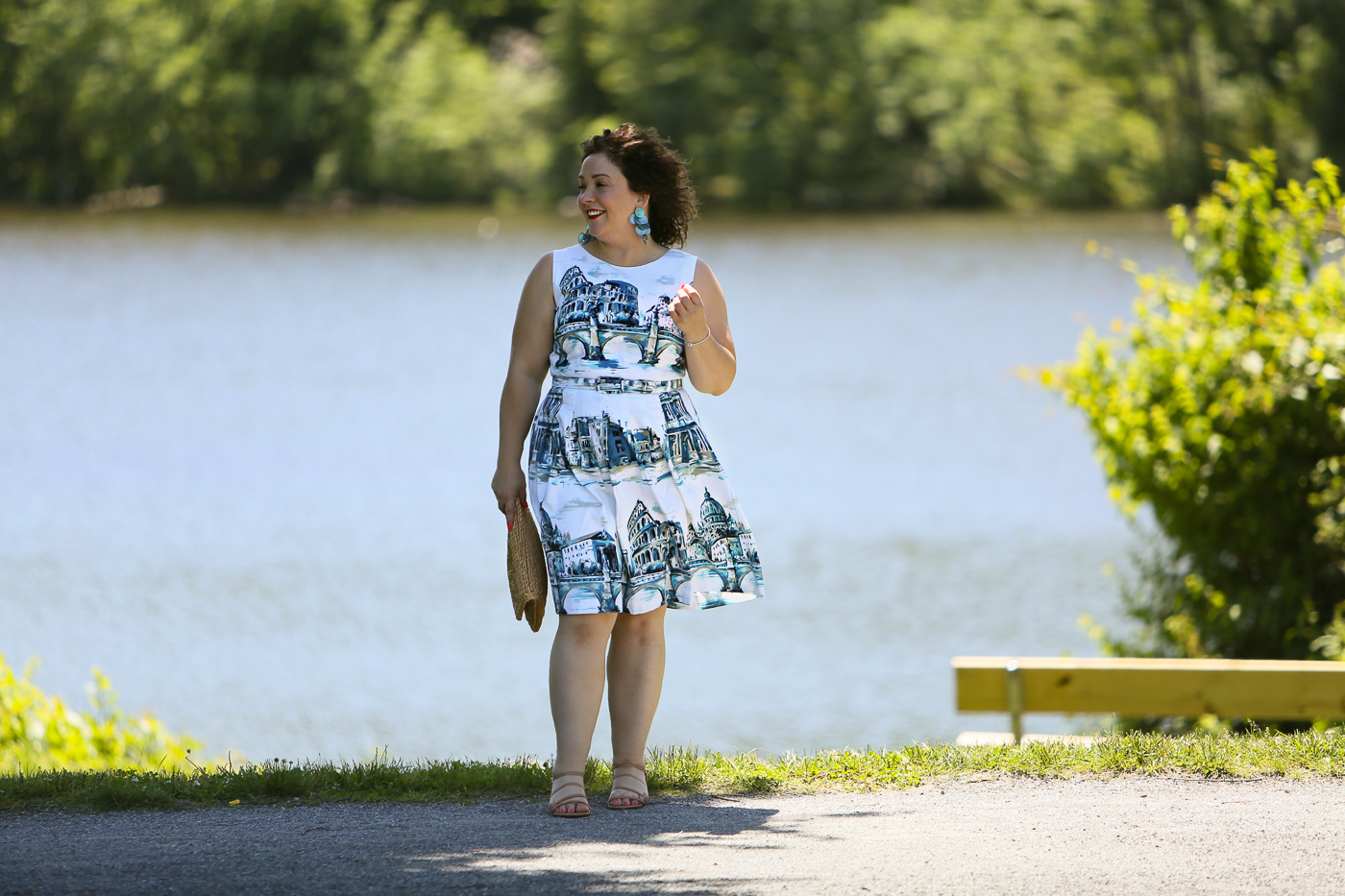 Rome-inspired printed fit and flare dress from Talbots styled with a woven straw clutch purse, Zara earrings, and Talbots wide width wedge sandals