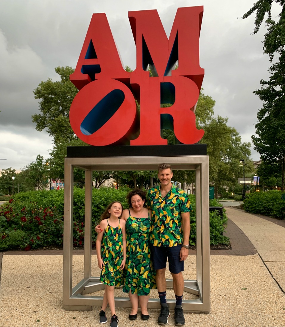 A family standing at the AMOR sculpture in Philadelphia