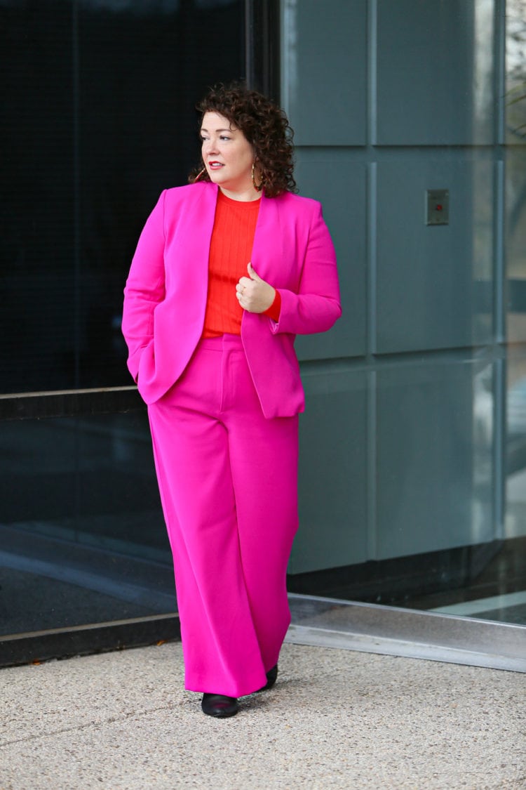 Alison Gary of Wardrobe Oxygen in a hot pink pantsuit from Banana Republic styled with an orange ribbed sweater