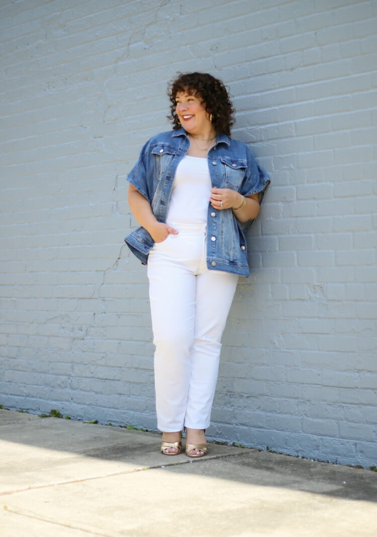 Alison wearing a summer ruana of denim from Chico's with white jeans and a tank. She is laughing and looking at something off camera