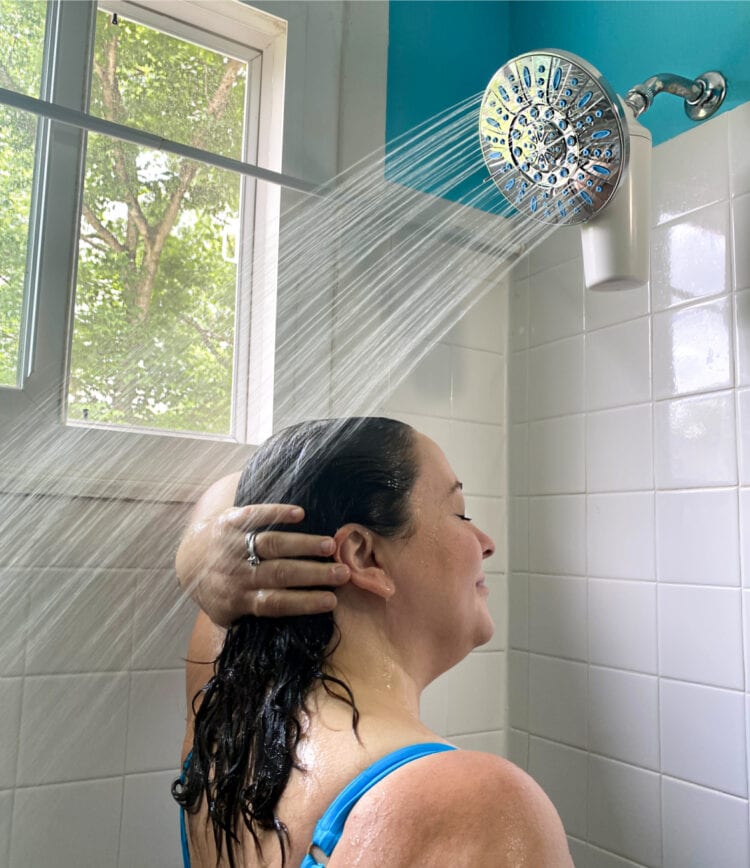 Alison of Wardrobe Oxygen using an Aquasana shower filter to wash her hair