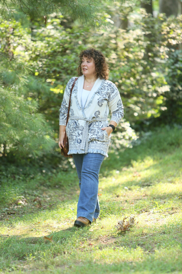 Wardrobe Oxygen in a Chico's belted cardigan sweater with a blue print on ivory