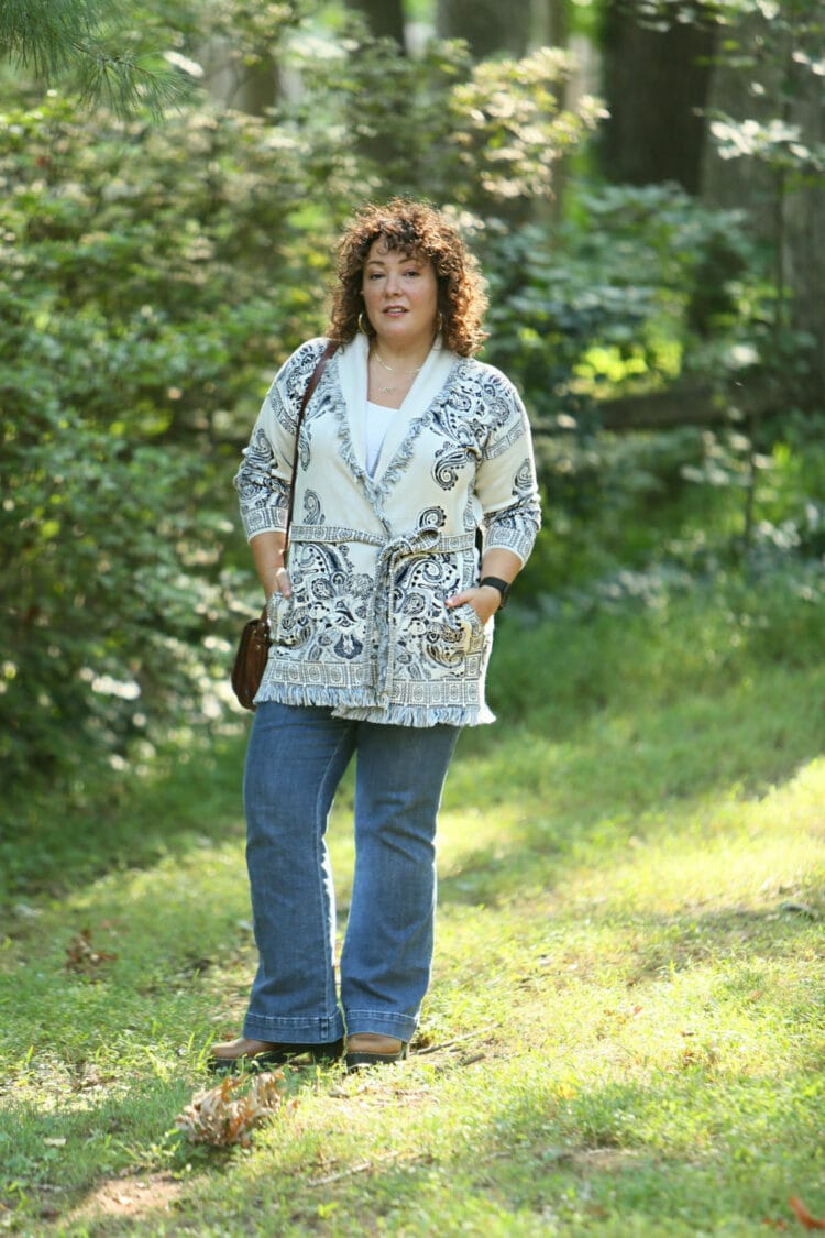 Wardrobe Oxygen in a Chico's belted cardigan sweater with a blue print on ivory