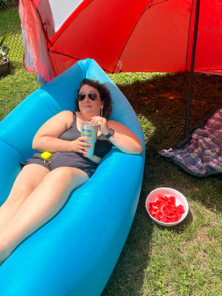 Alison Gary of Wardrobe Oxygen on a Fatboy lounger, sipping a beverage in a Royal Farms stainless tumbler