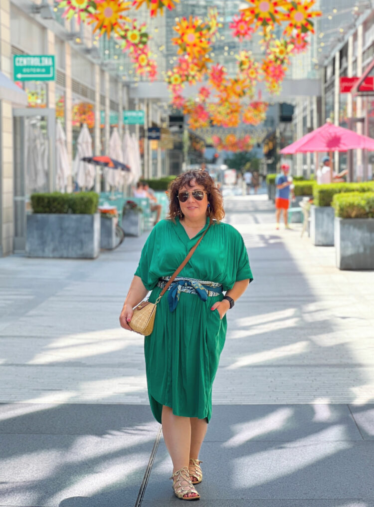 Alison Gary of Wardrobe Oxygen wearing a green ever by X dress while standing in City Center DC.