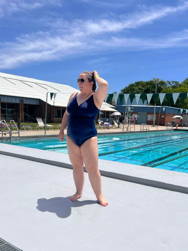 woman in a Lands' End navy swimsuit standing at the edge of a swimming pool