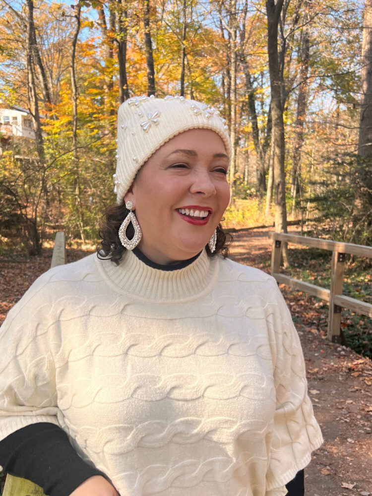 Alison in a cream Lele Sadoughi beanie and Deepa Gurnani handmade beaded statement earrings