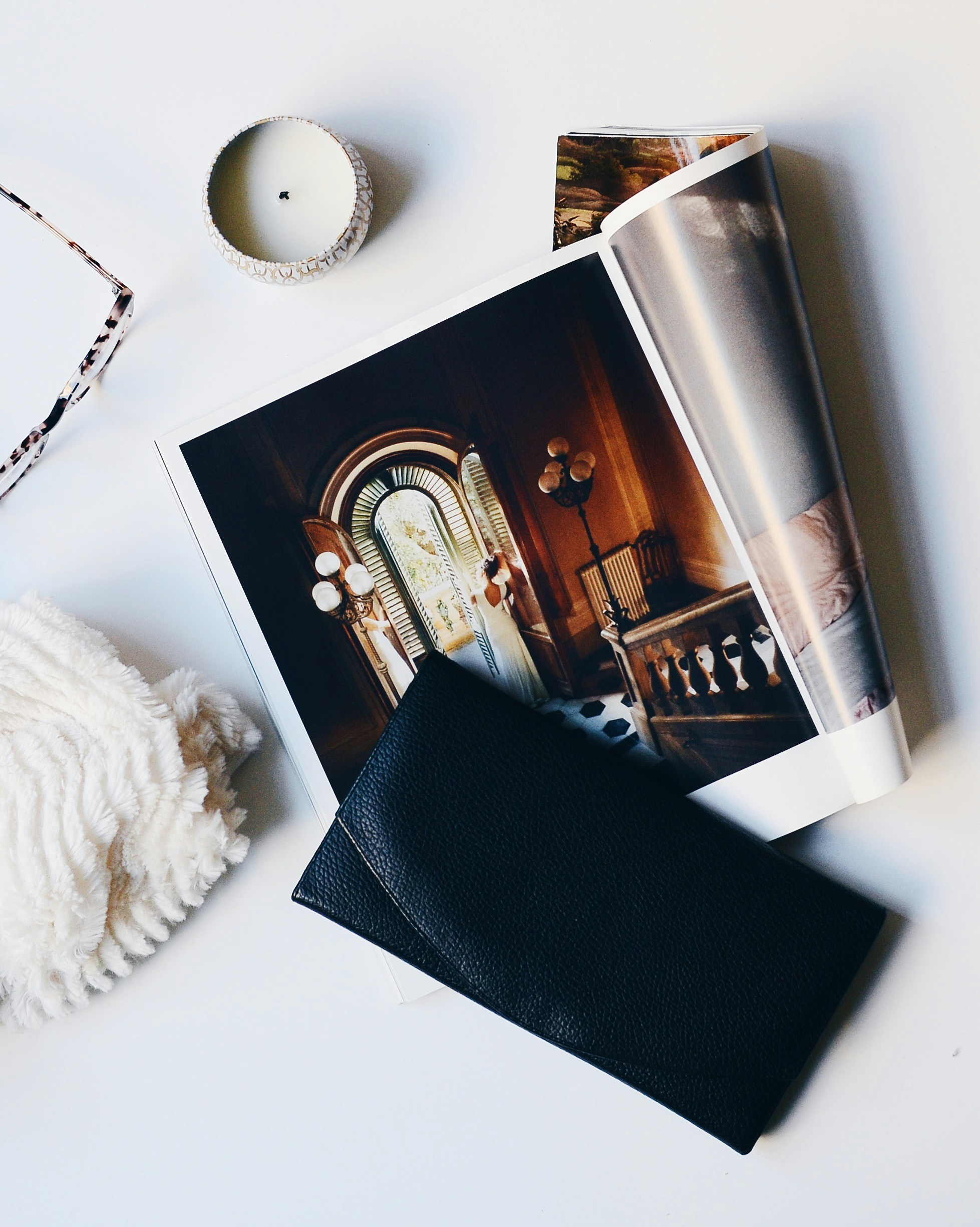 how to have style by Wardrobe Oxygen. Real-life style for grown-ass women. Photo of a clutch purse, a fashion magazine, and stylish accessories on a white table