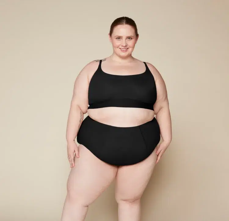 Plus size model wearing a black bralette and the Harper Wilde No Show Highwaist Brief