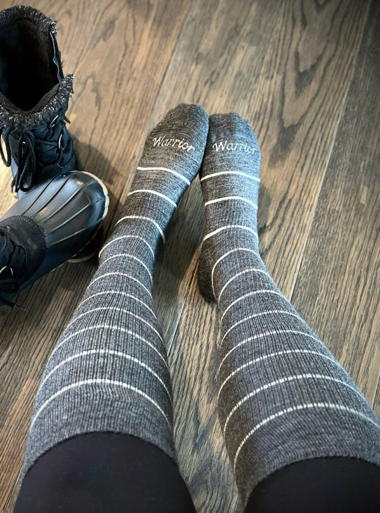 women's legs wearing gray and white striped knee socks that are the Swell Compression Socks from Warrior Alpaca Socks