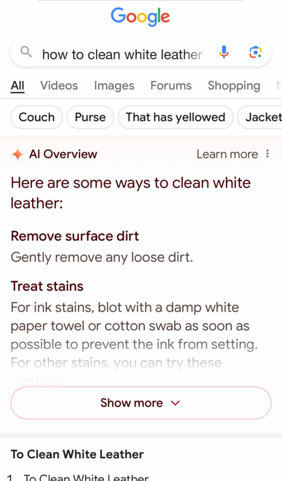 A user searching for how to clean white leather on Google. The first thing found are tips from AI with a "show more" to read more tips provided by AI.