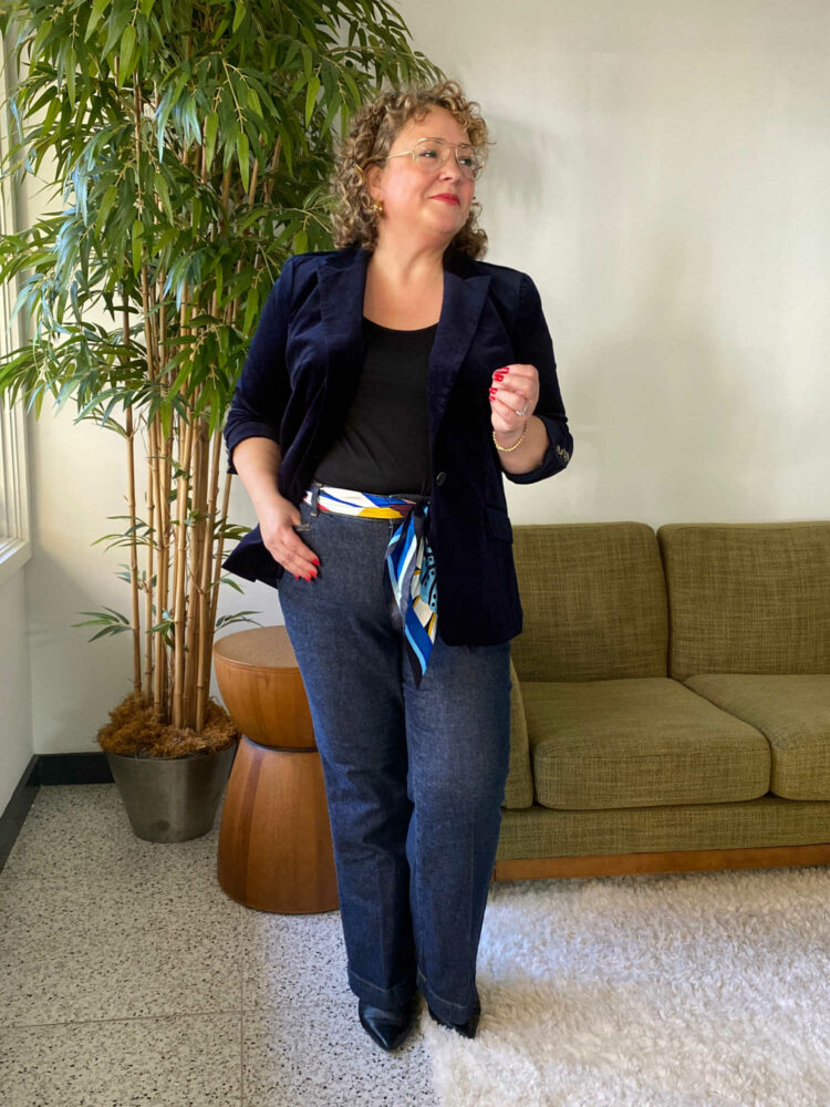 Alison Gary of Wardrobe Oxygen in a navy Talbots velveteen blazer with flare jeans and a scarf as a belt