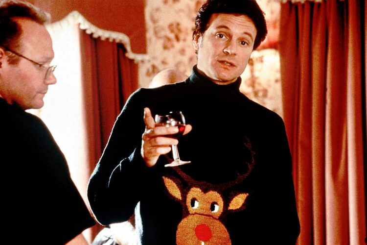 Colin Firth as Mr. Darcy in the 2001 film Bridget Jones' Diary, wearing an ugly Christmas sweater with a moose on the front