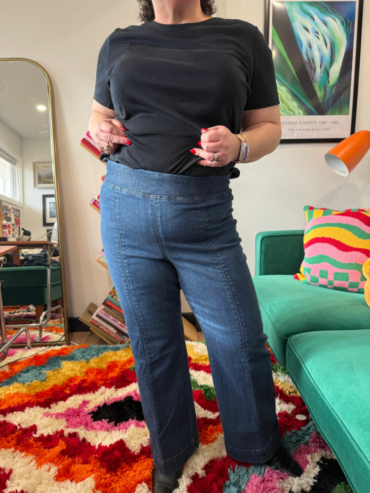 Alison Gary in a black t-shirt tucked into the Talbots Flare Leg Pull-on Travel Jeans