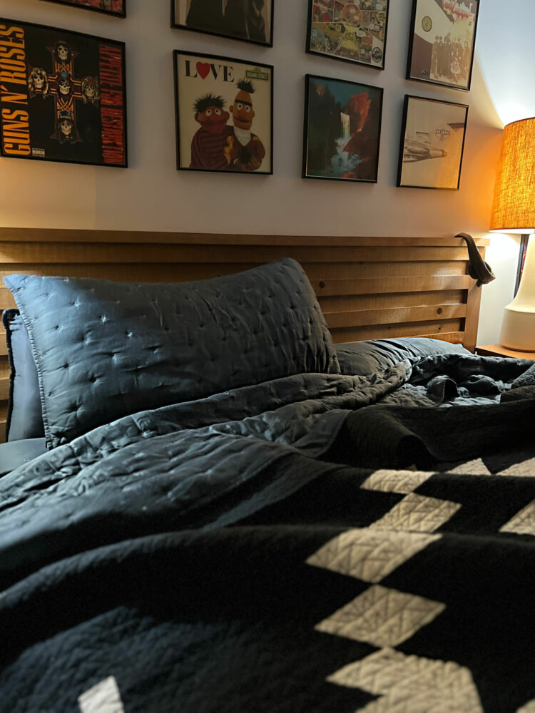 quince bamboo bedding with a black and white Pendleton quilt on a wooden bed