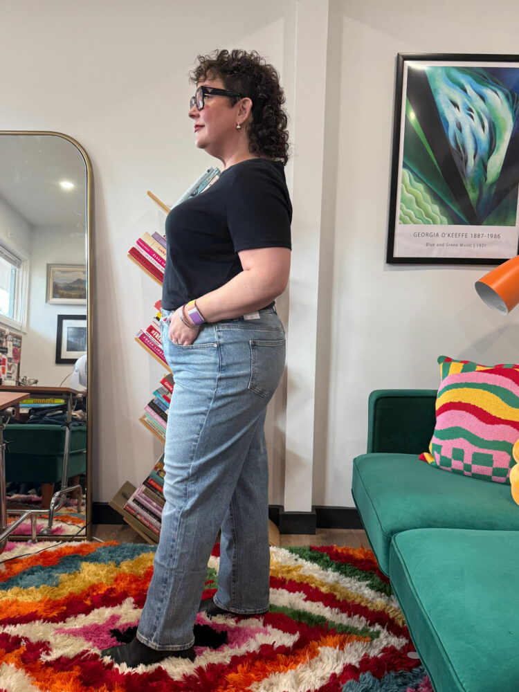 Alison Gary in a black t-shirt tucked into the Talbots High Waist Relaxed Jeans - Allenby Wash