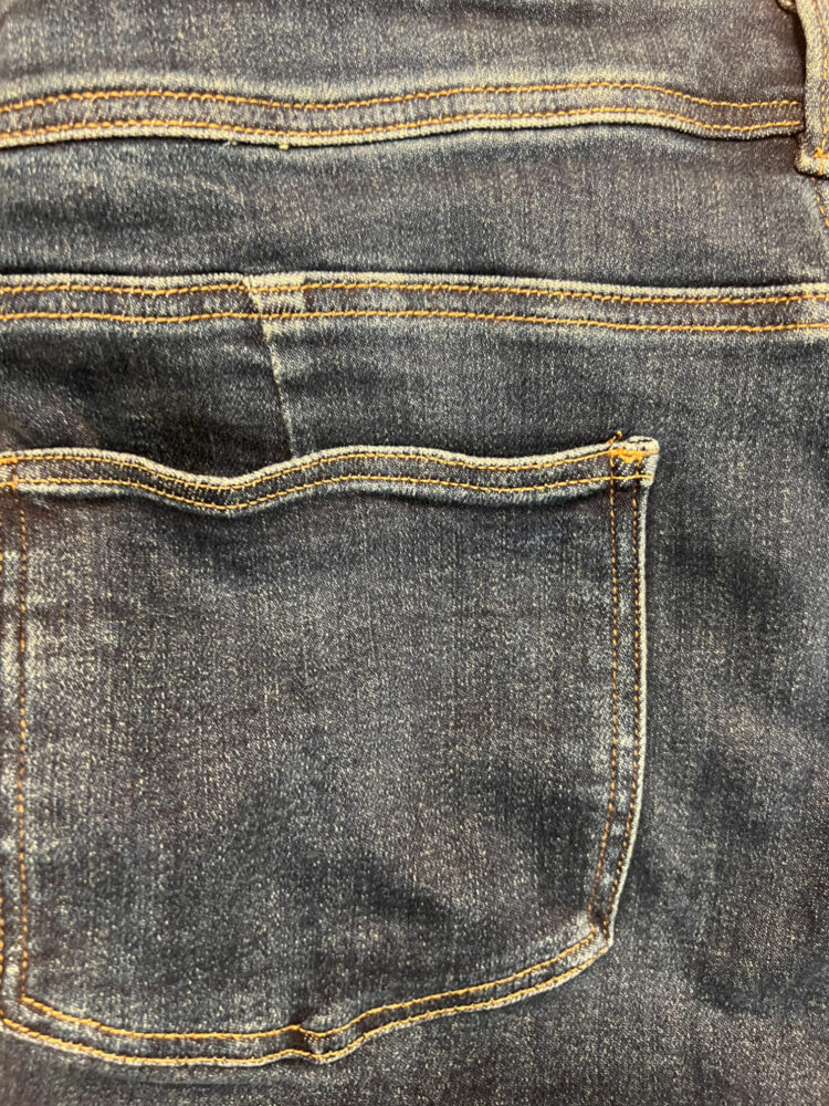 closeup of a back pocket and the pleat and yoke of the universal standard perfect jeans