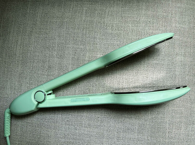The Nori Press steam iron in green, showing how it stays open and doesn't clamp shut