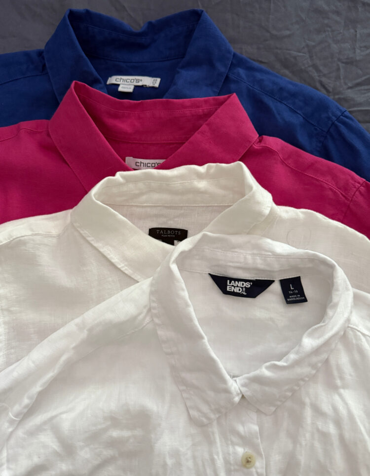 What Clothes I Pack Away on Labor Day - in photo: a stack of four linen button-front shirts for women
