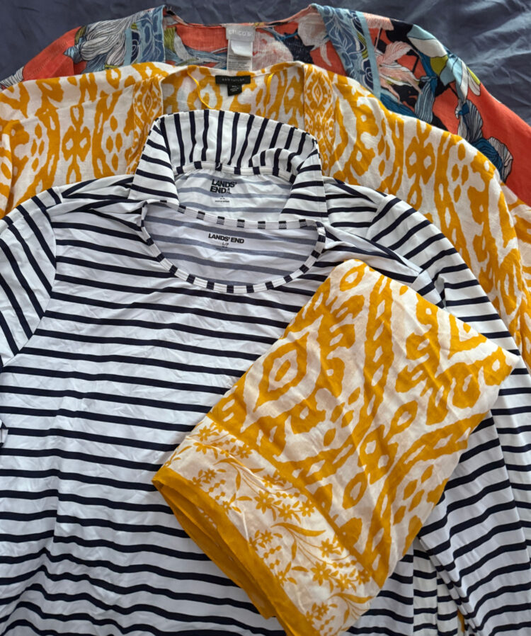 What Clothes I Pack Away on Labor Day - in photo:  a collection of linen coverups, pareos, and rashguards for women