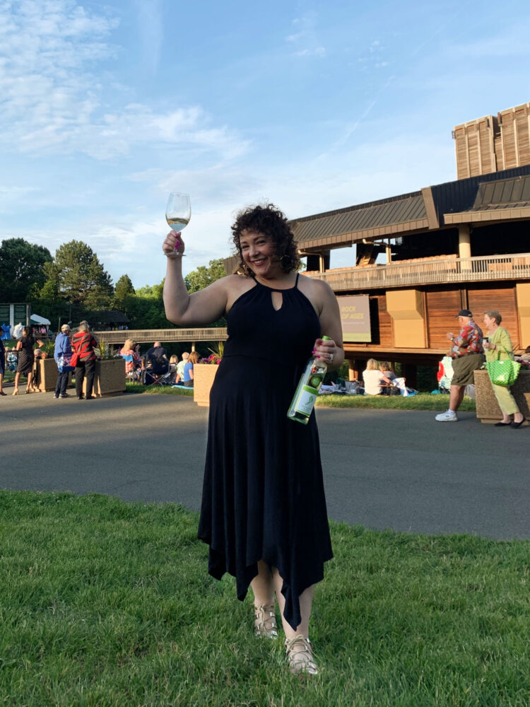 Wolf Trap for Johnny mathis Woman at Wolf Trap for Johnny mathis wearing a black knit dress and flat sandals